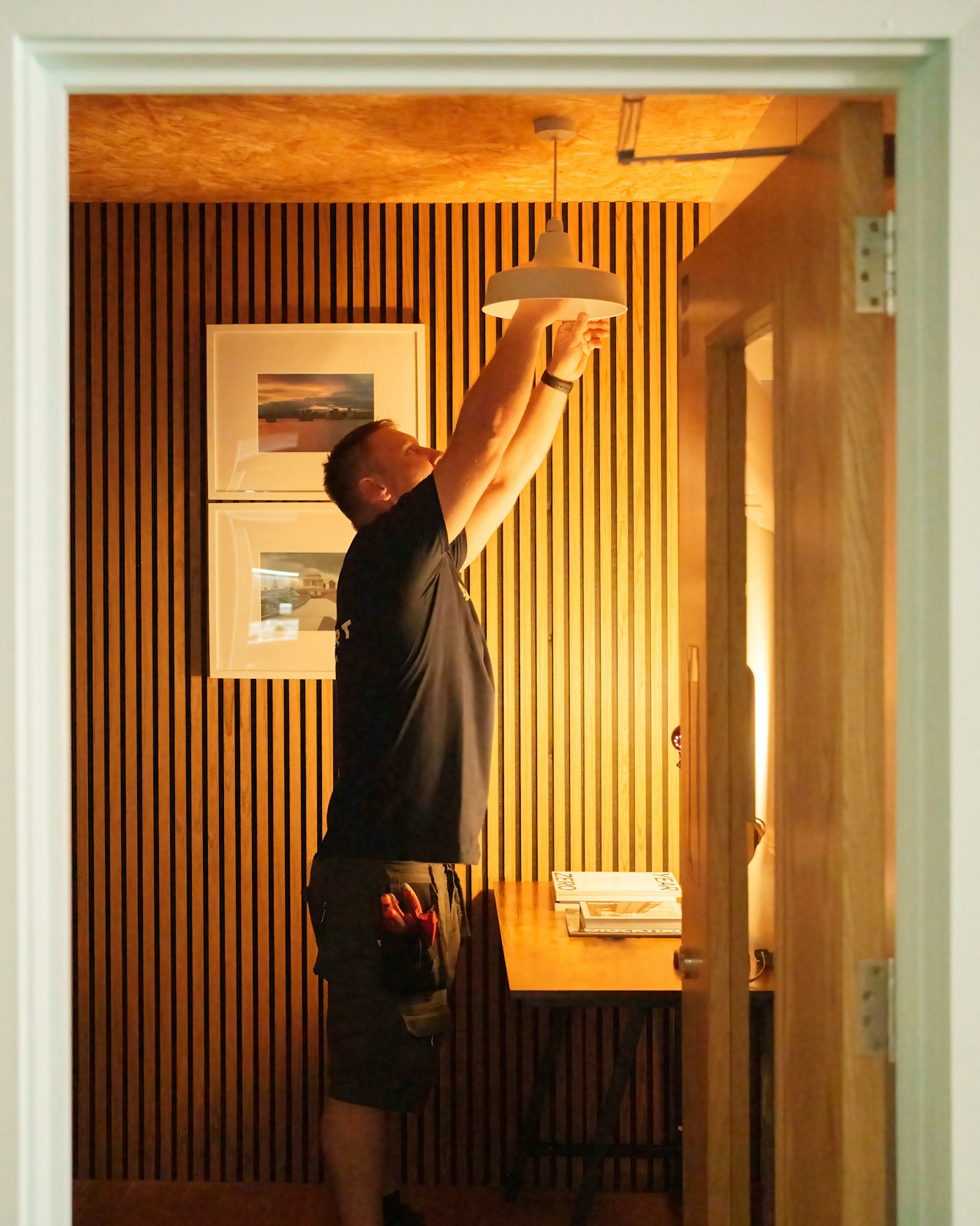 Handyman installing a ceiling light fixture