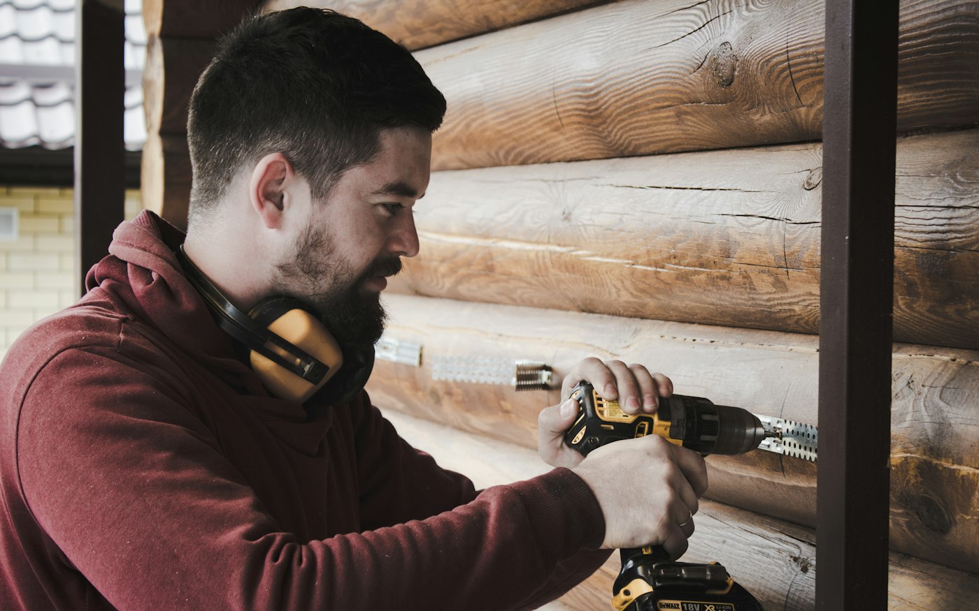 Handyman using a cordless drill to install wall hardware